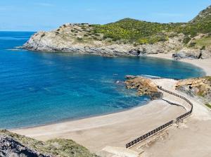 a beach on a cliff with the ocean at B&B Al Centro - Ossi in Ossi