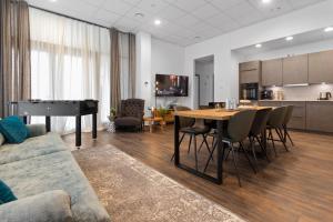 a living room with a table and a piano at Flatista Homes - Aubing in Munich