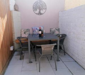 a table with chairs and a bottle of wine on it at No 12 B&B in Dungarvan