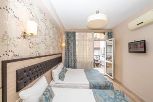 a hotel room with two beds and a window at Tugra Hotel in Istanbul +119 photos