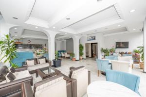 a lobby of a hospital with chairs and tables at Tugra Hotel in Istanbul