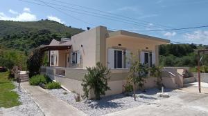 a house with a mountain in the background at Villa Evridiki in Georgioupolis