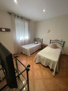 Ένα ή περισσότερα κρεβάτια σε δωμάτιο στο HOSTAL CHIQUININO II