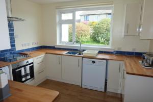 a kitchen with a sink and a window at Tir Nan Og in Rockcliffe