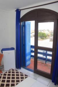a room with a door open to a balcony at Hotel Mar Navegantes in Pinhal