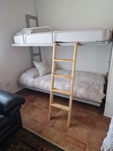 a bunk bed with a ladder in a room at Naturaleza playas y montañas in Cabezón de la Sal