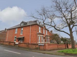 a red brick house on the side of a street at Victoria Court in Weymouth