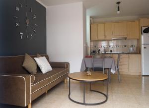 a living room with a couch and a table and a kitchen at Apartamento O SALEIRO in Padrón