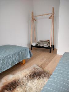 a bedroom with a bed and a rug on a wooden floor at Ny bolig i grønne omgivelser. in Rødovre