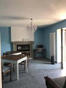 - un salon avec une table à manger et une cheminée dans l'établissement APPARTAMENTO POGGIGRILLi, à Pievepelago
