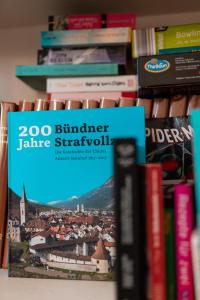 a book shelf filled with books at Bogentrakt in Chur