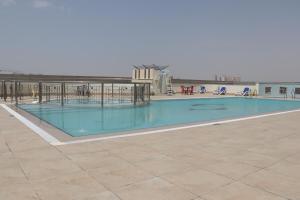 a large swimming pool on top of a building at ABIDOS HOLIDAY HOMES Windsor Residence in Dubai
