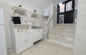 a bathroom with a sink and a staircase at La casa di mammina in Bari