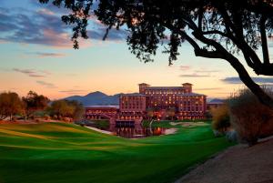 a view of the hotel from the golf course at sunset at The Westin Kierland Resort & Spa in Scottsdale