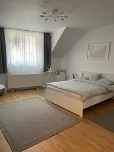 a bedroom with a bed and a large window at Apartament Agnes in Braşov