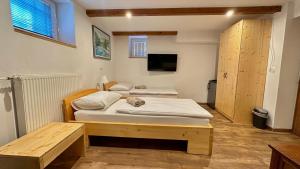 a room with two beds and a tv in it at Vila Eva Lesce - Bled in Lesce