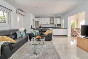 a living room with a couch and a table at Casa Ambar in Nerja