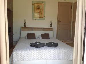 a bedroom with a bed with two towels on it at Mas Madilauric 2 BNB in Peymeinade