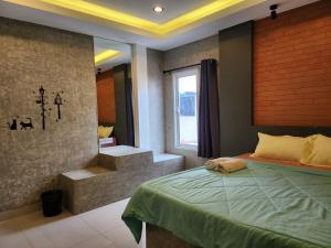 a bedroom with a bed and a window and stairs at Loft House Resort Pattaya in Jomtien Beach