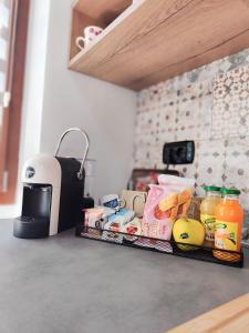 a kitchen counter with food and a toaster on it at B&B Al Centro - Ossi in Ossi +15 photos