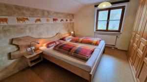 a bedroom with a bed with a wooden headboard at Haus Eckwiesen in Bad Hindelang