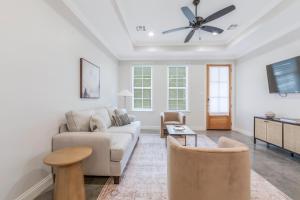 a living room with a couch and a table at Charming Cottage built in 2019 in Lafayette