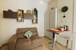 a living room with a couch and a table at In centro apartment in Palermo