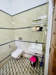 a bathroom with a sink and a toilet at Nandana's Residency Munnar in Munnar