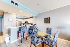a kitchen and dining room with a table and chairs at Destin West Resort - Bayside Pelican PH5 in Fort Walton Beach