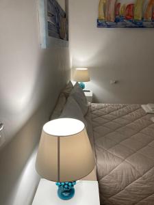 A bed or beds in a room at VILLA AZZURRA beachfront Mondello - Palermo