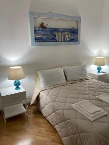 A bed or beds in a room at VILLA AZZURRA beachfront Mondello - Palermo