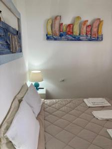 A bed or beds in a room at VILLA AZZURRA beachfront Mondello - Palermo