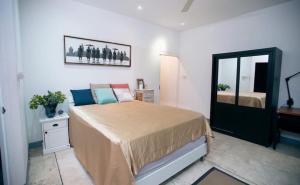 a bedroom with a bed and a mirror at Chiang Mai luxury condo hidden in the city in Chiang Mai