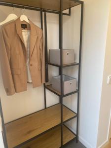 a closet organizer with three boxes and a jacket at Monsunen in Sölvesborg