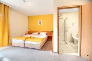 a bedroom with a bed and a bathroom with a shower at TaaakaRyba in Kołobrzeg