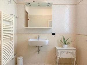 a bathroom with a sink and a mirror at Casa Ulivi Rosso in Rivoltella