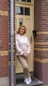 une femme se tient devant une porte dans l'établissement Inn den Acht Venlo, à Venlo