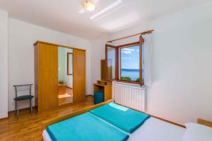 a room with a bed and a large window at One-Bedroom Apartment Crikvenica 6 in Dramalj
