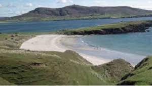 a beach in the middle of a body of water at Teach Greannai POD 2 Ensuite in Curraunboy