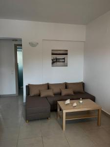 a living room with a couch and a coffee table at Bouvegio Apartments Vera in Afantou