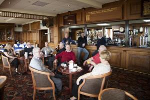 a group of people sitting in a restaurant at Somerfield Lodge in Swansea