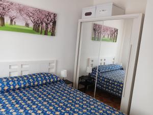 a bedroom with a bed and a mirror at Bilocale Kenya in Caorle