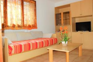 a living room with a couch and a table at Residence Milena in Milano Marittima