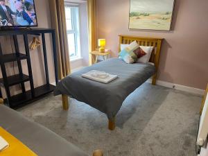 a bedroom with a bed with a tray on it at Kings Arms in Llandysul
