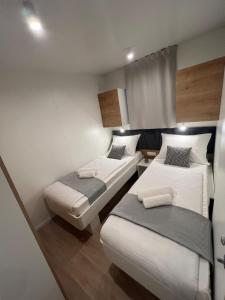 a small room with two beds in it at Mobile Homes MaLu in Biograd na Moru +67 photos