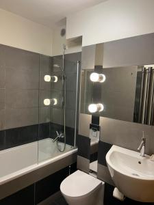 a bathroom with a toilet and a sink and a shower at Apartament Baryłka in Kazimierz Dolny +20 photos