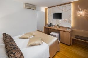 Ein Bett oder Betten in einem Zimmer der Unterkunft Hotel Cittar