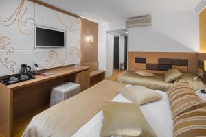 Ein Bett oder Betten in einem Zimmer der Unterkunft Hotel Cittar