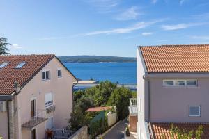 a view of the ocean from between two buildings at One-Bedroom Apartment in Crikvenica XI in Dramalj