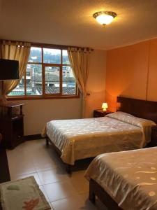 Postel nebo postele na pokoji v ubytování HOTEL El INDIO